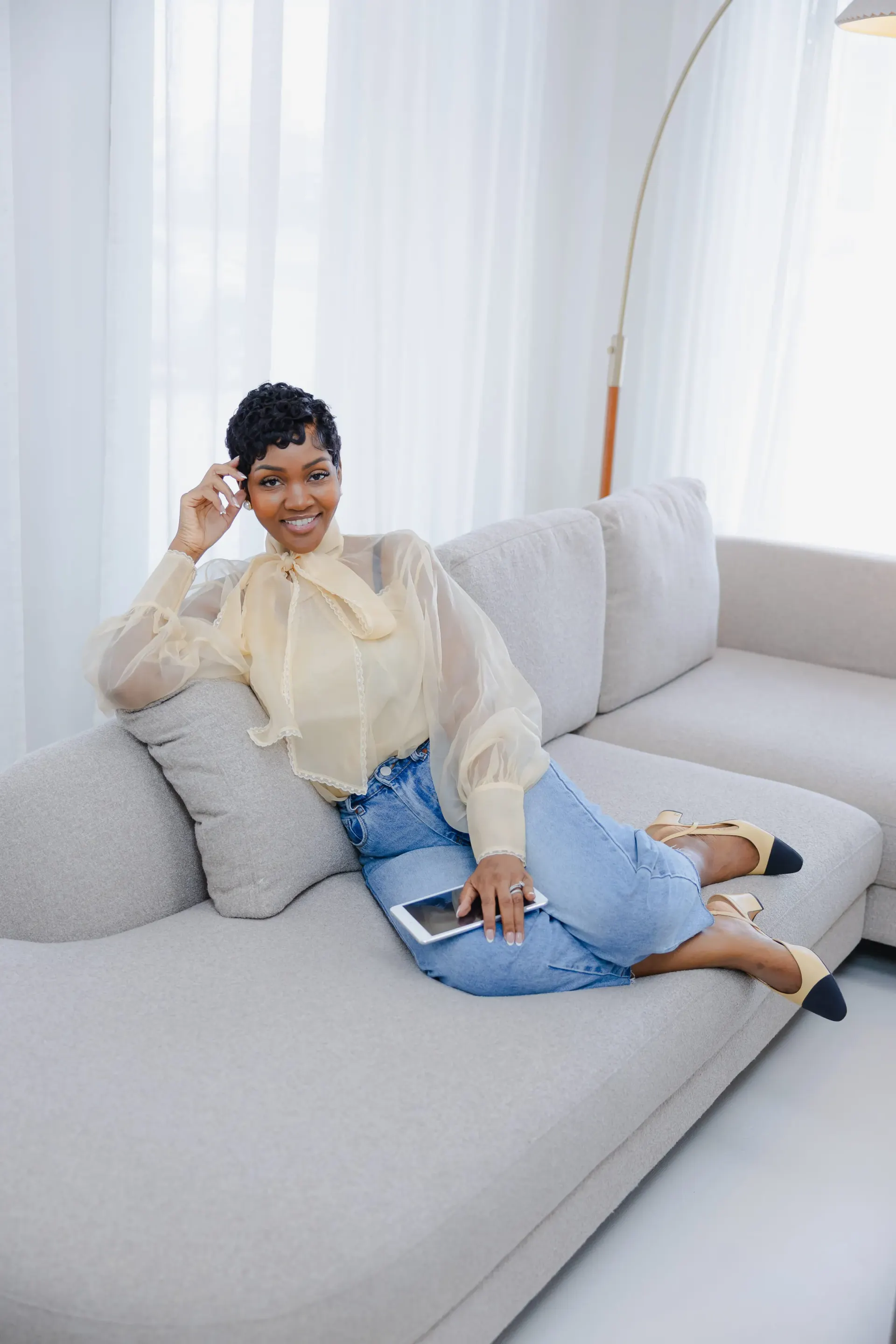 Cleo R. smiling while reviewing a tablet